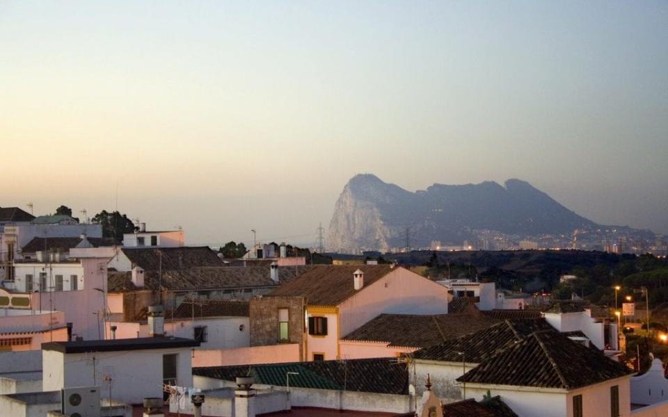 The Rock is seen over San Roque roofs at dusk - Credit: RaMaOrLi