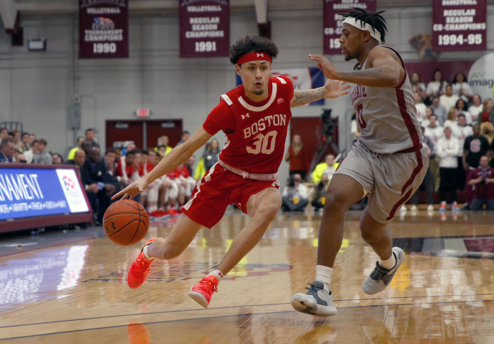 Boston University's Javante McCoy (30) drives past Colgate's Nelly Cummings (0) during the first half of the NCAA Patriot League Conference college basketball championship at Cotterell Court, Wednesday, March 11, 2020, in Hamilton, N.Y. (AP Photo/John Munson)
