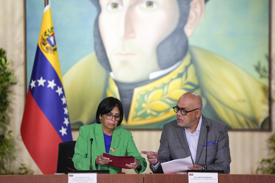 Venezuelan Vice President Delcy Rodriguez talks with National Assembly President Jorge Rodriguez during a meeting at the Foreign Ministry in Caracas, Venezuela, Monday, Dec. 11, 2023. Leaders of Guyana and Venezuela are preparing to meet this week to address an escalating dispute over the Essequibo region that is rich in oil and minerals. (AP Photo/Matias Delacroix)