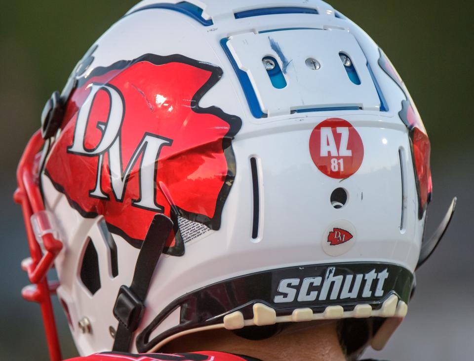 Dee-Mack players sport stickers honoring JFL player Adrian Zehr, who was hit and killed by a car in July, during their football game Friday, Sept. 1, 2023 against Gibson City-Melvin-Sibley in Mackinaw.