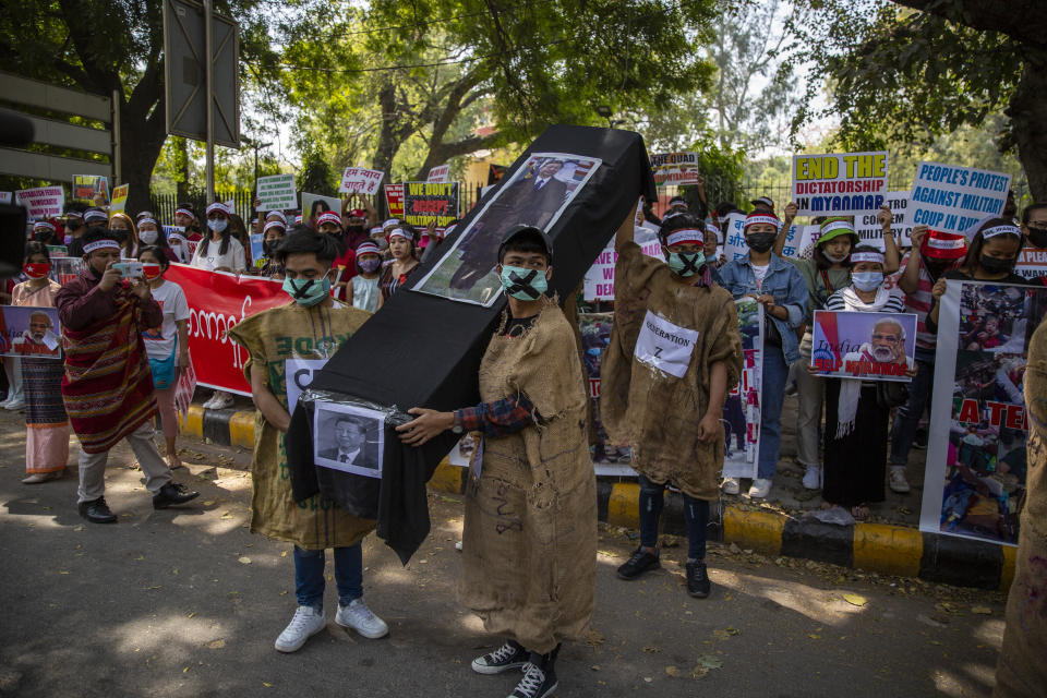 Chin refugees from Myanmar carries a mock coffin of Chinese President Xi Jinping during a protest against military coup in Myanmar, in New Delhi, India, Wednesday, March 3, 2021. (AP Photo/Altaf Qadri)