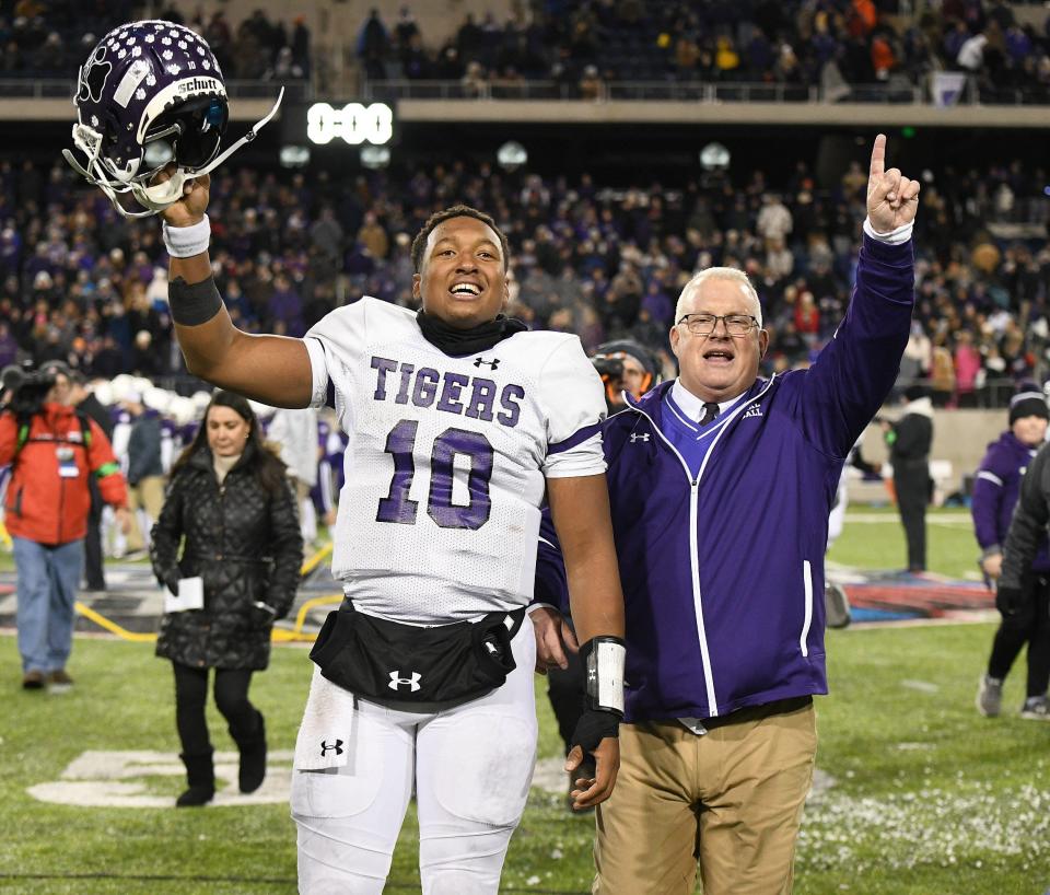Pickerington Central quarterback Demeatric Crenshaw and coach Jay Sharrett acknowledge the fans following the Tigers' 21-14 win over Cincinnati Elder in the Division I state championship game Dec. 6, 2019, at Tom Benson Hall of Fame Stadium in Canton.