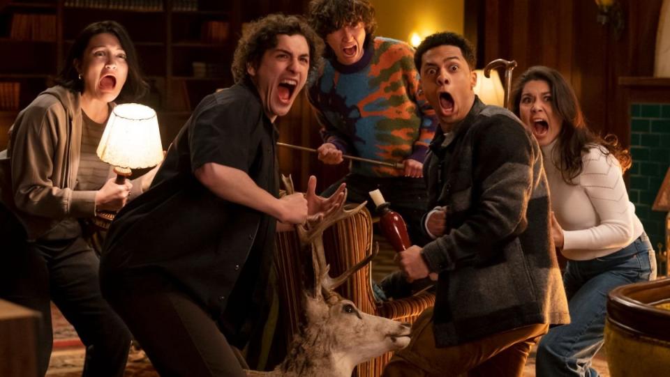 goosebumps trailer still of five teenagers screaming at something scary while holding a lamp and a deer head