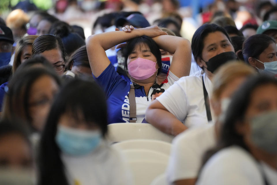 A supporter of Quezon City Mayor Joy Belmonte rests during an event as she starts her re-election campaign in Quezon City, Philippines on Friday, March 25, 2022. Candidates for thousands of provincial, town and congressional posts started campaigning across the Philippines Friday under tight police watch due to a history of violent rivalries and to enforce a lingering pandemic ban on handshakes, hugging and tightly packed crowds that are a hallmark of often circus-like campaigns. (AP Photo/Aaron Favila)