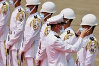 A Taiwan Navy honor guard captain adjusts a team member's face mask during a launch ceremony for Taiwan Navy's domestically built amphibious transport dock "Yushan" in Kaohsiung,