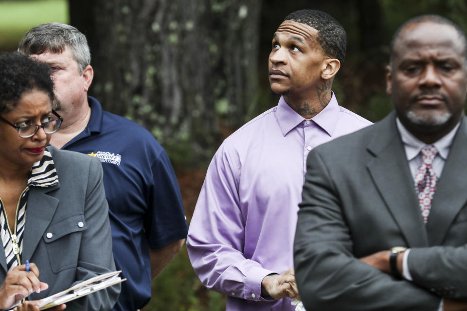 Defendant Quinton Tellis, center, looks around during a court field trip to the crime scene in Courtland, Miss. on Thursday, Sept.27, 2018. Tellis is charged with burning 19-year-old Jessica Chambers to death almost three years ago on Dec. 6, 2014. He has pleaded not guilty to the murder. (Brad Vest/The Commercial Appeal via AP, Pool)