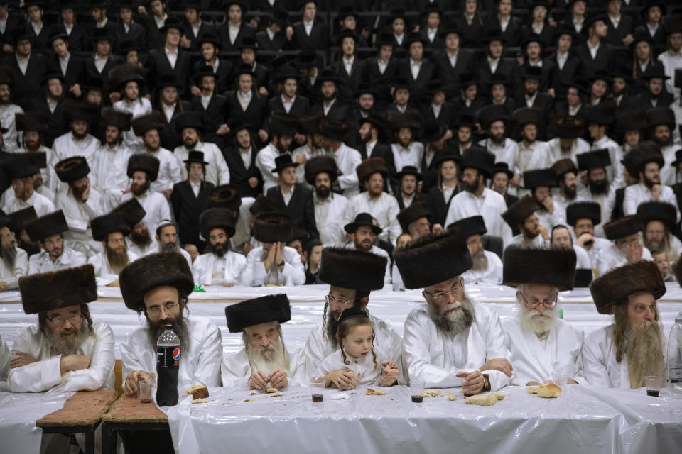 Ultra-Orthodox Jews, members of the Lelov Hassidic dynasty attend the "Pidyon Haben" ceremony of the great grandchild of their chief rabbi Aharon Biderman in Beit Shemesh, Israel, Thursday, Sept. 16, 2021. The Pidyon Haben, or redemption of the firstborn son, is a Jewish ceremony hearkening back to the biblical exodus from Egypt. (AP Photo/Oded Balilty)