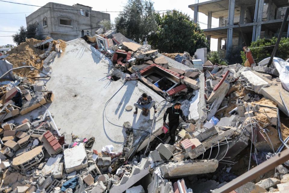 People inspect the damage to their homes following Israeli air strikes on Tuesday in Rafah, Gaza (Getty Images)