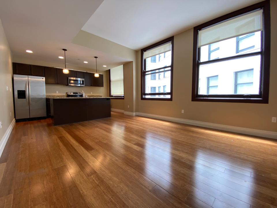 The living room and kitchen in the David Whitney.