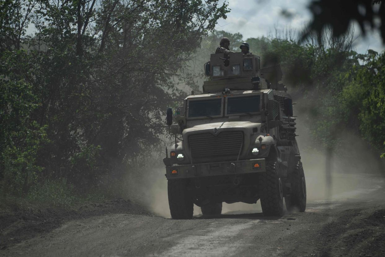 Ukrainian servicemen ride on an armoured personnel carrier (APC) on a road toward Bakhmut, Donetsk region (AFP via Getty Images)