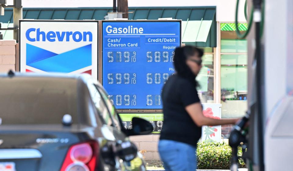 Gas prices, with the most expensive price per gallon at $5.79, are displayed at a California gas station.