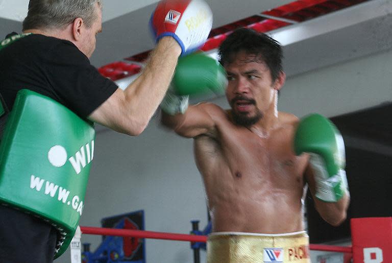 Philippine boxing hero Manny Pacquiao (R) trains with his coach Freddie Roach at a gym in General Santos City, on the southern island of Mindanao on October 24, 2013