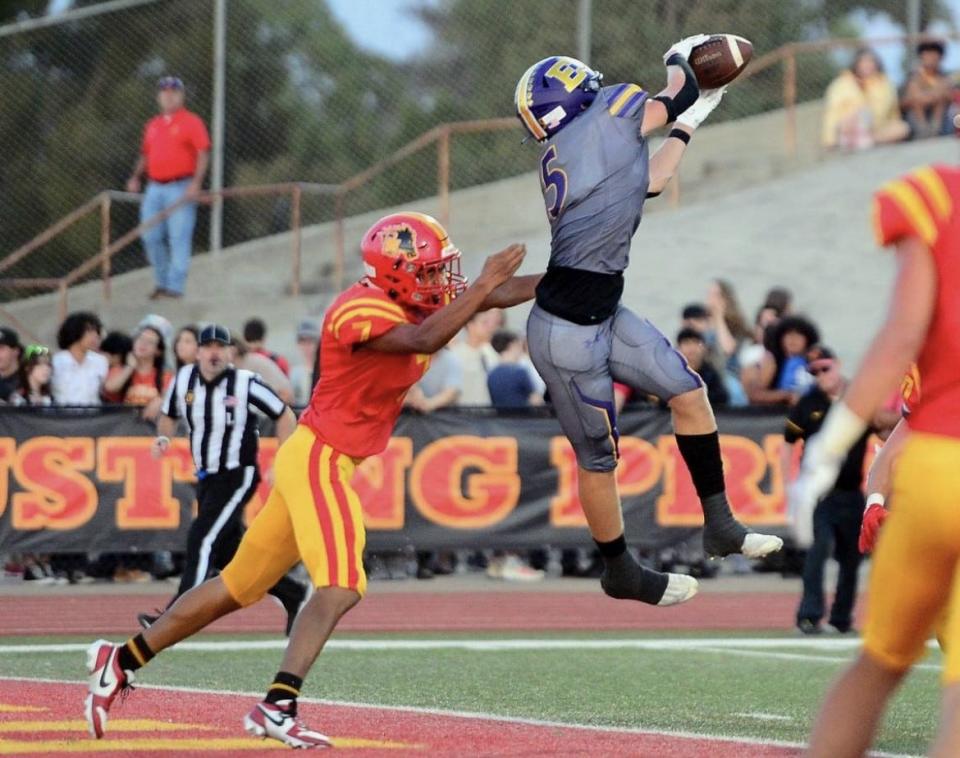 Escalon's Sam Jimenez catches a pass in front of an Oakdale defender during the Cougars game against Oakdale during the 2023-24 season.