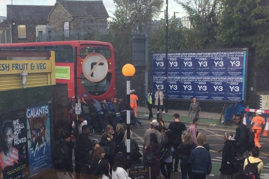 Commuter spirit: Londoners push a broken down bus in Finsbury Park