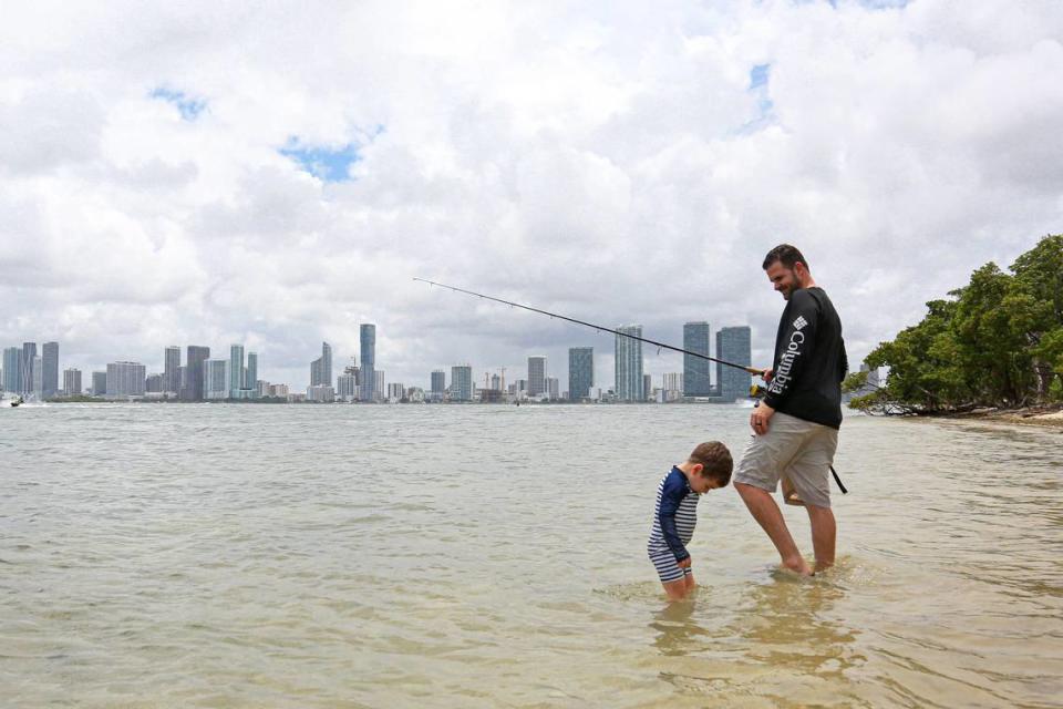 Michael Prado enjoys time with his son as they go fishing by the Julia Tuttle Causeway in Miami during the first day of Memorial Day Weekend, Saturday, May, 23, 2020.