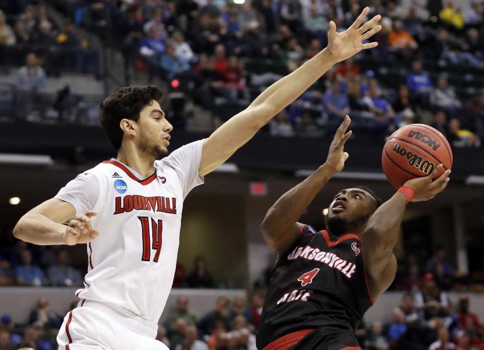 Jacksonville State's Tyrik Edwards (4) heads to the basket as Louisville's Anas Mahmoud (14) defends during the second half of a first-round game in the men's NCAA college basketball tournament Friday, March 17, 2017, in Indianapolis, Mo. Louisville won 78-63. (AP Photo/Jeff Roberson)