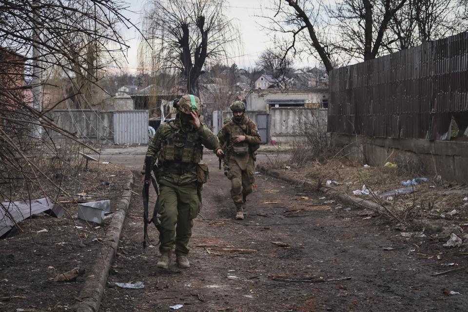 Ukrainian soldiers walk along a street in the area of the heaviest battles with the Russian invaders in Bakhmut, Donetsk region, Ukraine, Wednesday, March 15, 2023.  (Roman Chop / AP)