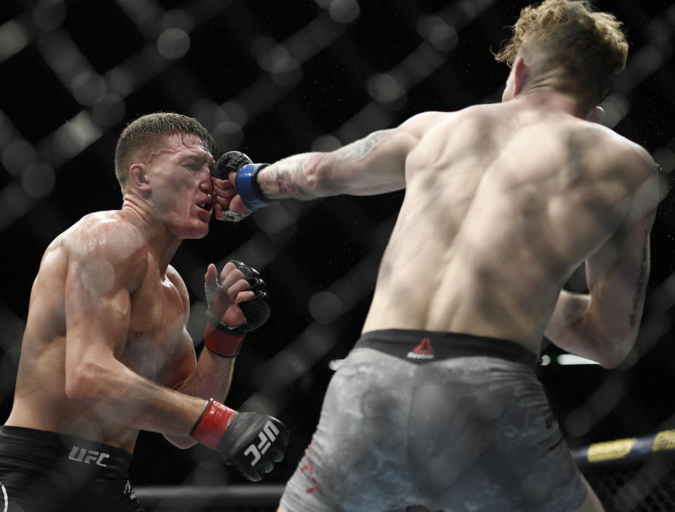In this Sunday, Feb. 10, 2019, file photo, New Zealand's Shane Young, left, and Austin Arnett of the U.S., fight, during their featherweight bout at the UFC 234 event in Melbourne, Australia. (AP Photo/Andy Brownbill, File)
