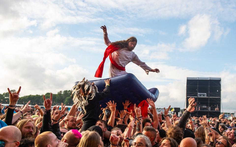 A man crowd surfs at Download Festival on 20 June 2021 - Katja Ogrin/Getty Images