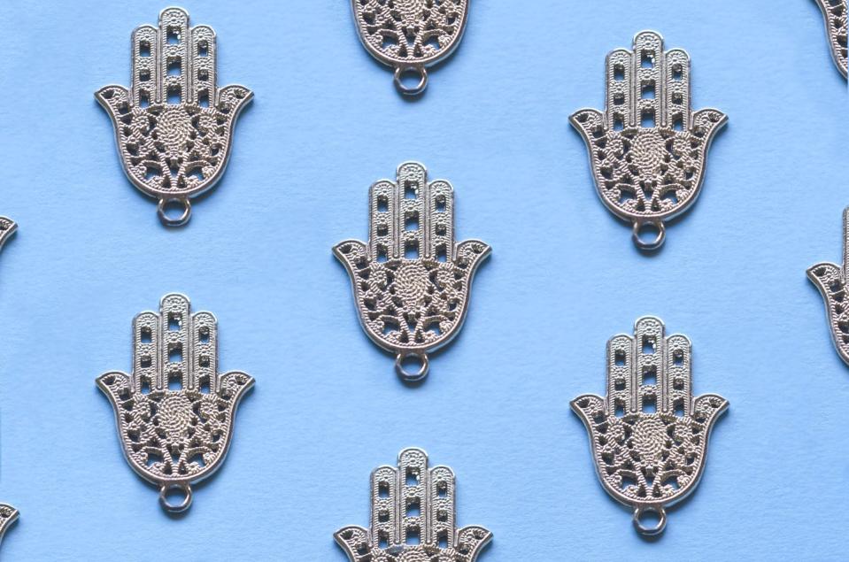 seamless pattern of hamsa hand on blue background