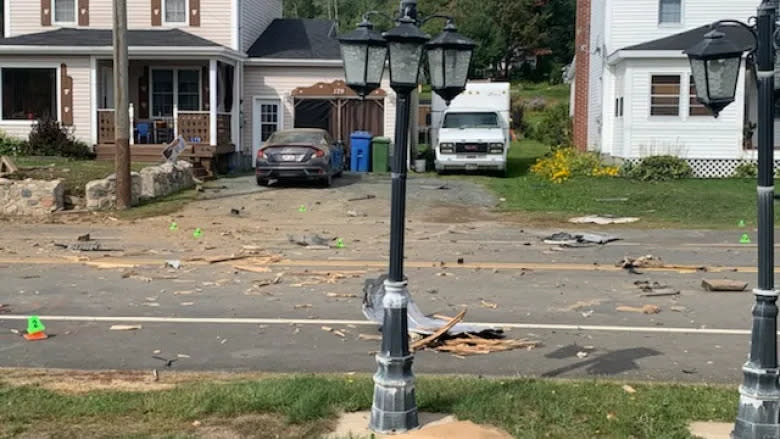 Debris is seen scattered across the ground in the village of Blackville, N.B., following a fatal crash early Sunday morning that left three teenage boys dead. (Submitted by Eric Walls)