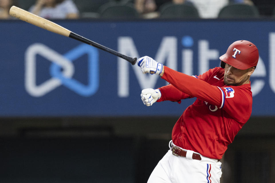 Texas Rangers' Nate Lowe loses control of his bat during the first inning of a baseball game against the Minnesota Twins in Arlington, Texas, Friday, June 18, 2021. (AP Photo/Andy Jacobsohn)