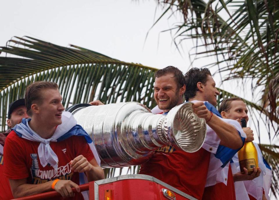 Florida Panthers center Aleksander Barkov (16) smiles while holding the Stanley Cup with teammates during the Florida Panthers Stanley Cup Victory parade on Sunday, June 30, 2024 down Fort Lauderdale Beach. 