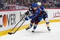 Colorado Avalanche defenseman Bowen Byram (4) is pressured by St. Louis Blues right wing Alexei Toropchenko (65) during the first period in Game 2 of an NHL hockey Stanley Cup second-round playoff series Thursday, May 19, 2022, in Denver. (AP Photo/Jack Dempsey)