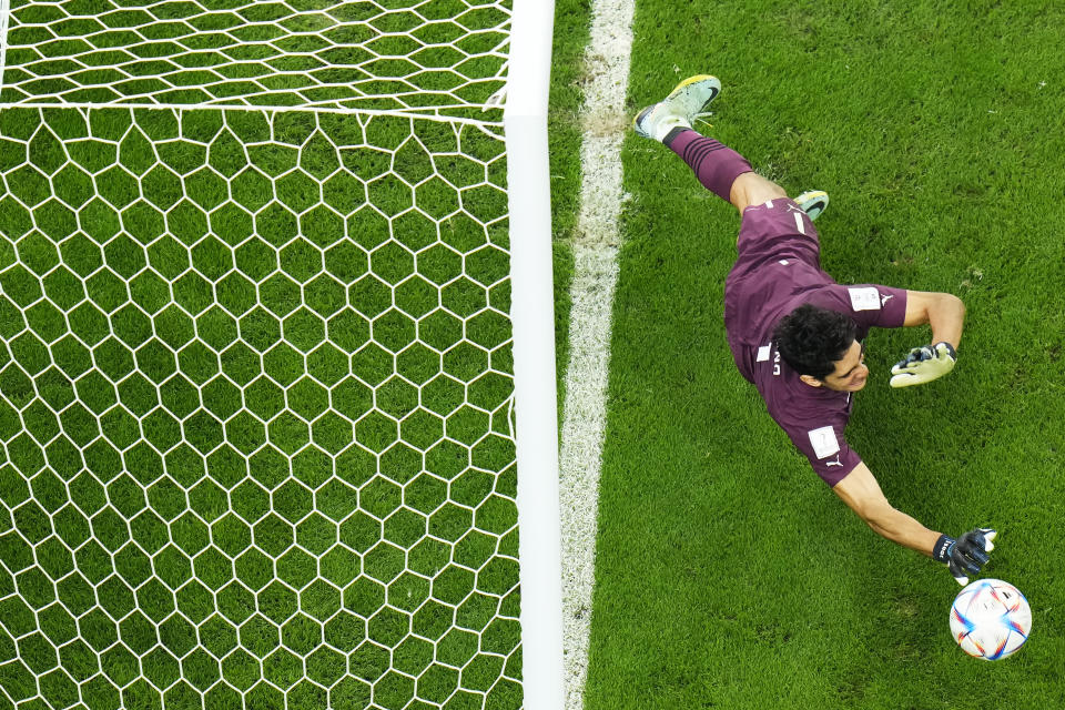 Morocco's goalkeeper Yassine Bounou saves a penalty kick during the World Cup round of 16 soccer match between Morocco and Spain, at the Education City Stadium in Al Rayyan, Qatar, Tuesday, Dec. 6, 2022. (AP Photo/Petr David Josek)