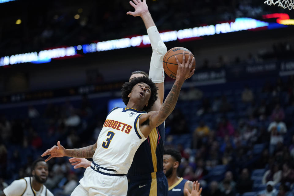 Denver Nuggets guard Bones Hyland (3) goes to the basket against New Orleans Pelicans center Jonas Valanciunas in the first half of an NBA basketball game in New Orleans, Wednesday, Dec. 8, 2021. (AP Photo/Gerald Herbert)