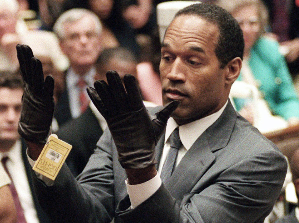 O.J. Simpson holds up his hands before the jury after putting on a new pair of gloves similar to the infamous bloody gloves during his double-murder trial in Los Angeles on June 21, 1995. (Vince Bucci / AP file)