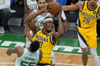 Indiana Pacers center Myles Turner (33) goes to the hoop against Boston Celtics guard Jeff Teague (55) in the first quarter of an NBA basketball game, Friday, Feb. 26, 2021, in Boston. (AP Photo/Elise Amendola)