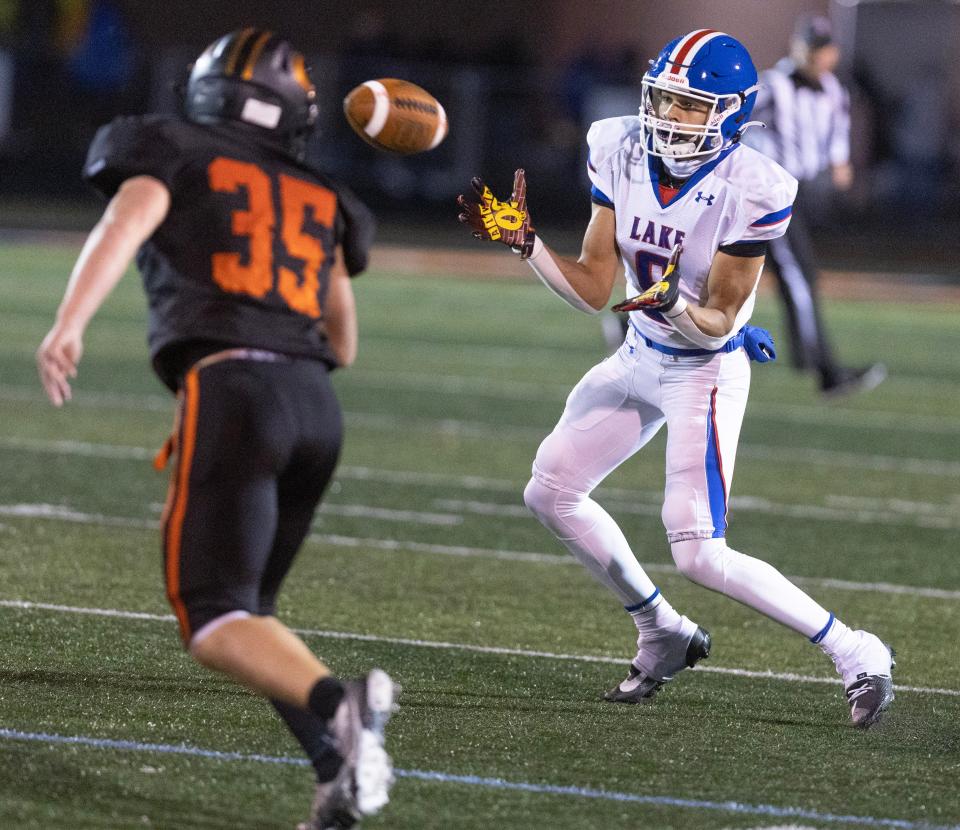 Lake's Kam'ron Fouty-Koonce reels in a pass as Green's Matt Galemmo defends in the second half at Green Friday, October 20, 2023.