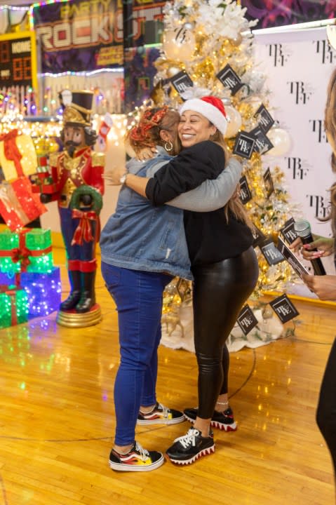 <em>Taneka Bowles, TBFE/TBFF CEO, embraces parent who received a donation. <br>Courtesy: Holly K Photography</em>