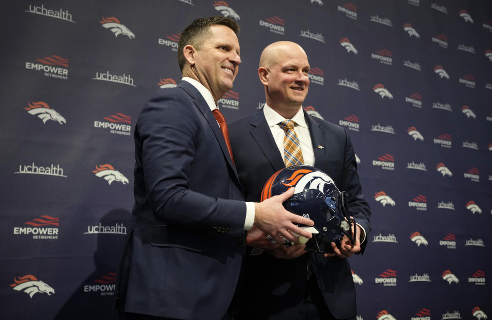 Denver Broncos general manager George Paton, left, joins new head coach Nathaniel Hackett for a photo after a news conference to introduce Hackett, Friday, Jan. 28, 2022, at the NFL football team's headquarters in Englewood, Colo. (AP Photo/David Zalubowski)