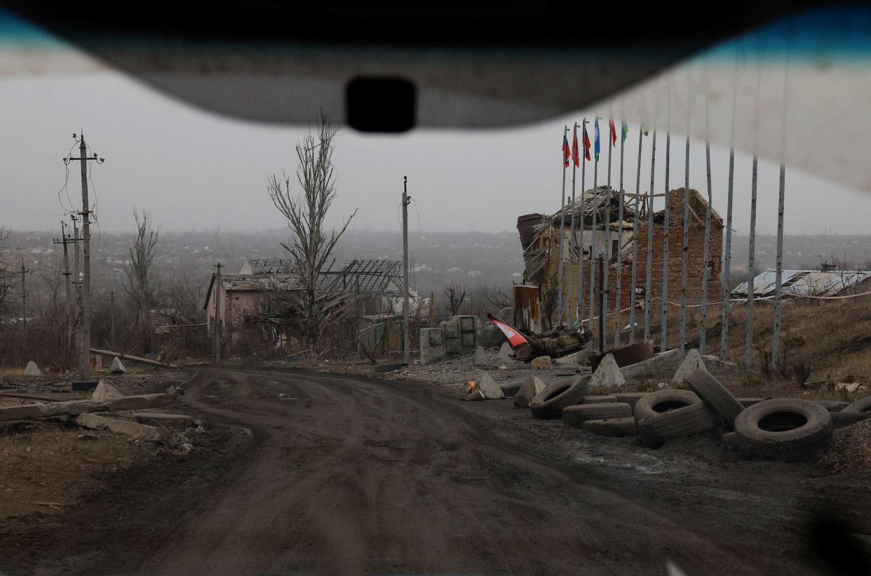 A view from a car shows buildings destroyed