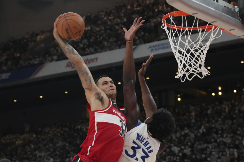 Washington Wizards' Kyle Kuzma, left, shoots over Golden State Warriors' James Wiseman during their preseason NBA basketball game, Friday, Sept. 30, 2022, at Saitama Super Arena, in Saitama, north of Tokyo. (AP Photo/Eugene Hoshiko)