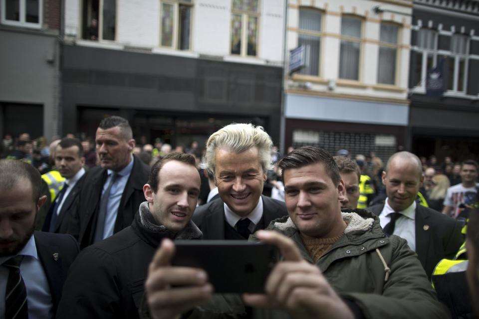 Firebrand anti-Islam lawmaker Geert Wilders, poses for a selfie with supporters during a campaign stop in Heerlen, Netherlands, Saturday, March 11, 2017. The Dutch electorate go to the polls for parliamentary elections of March 15. (AP Photo/Muhammed Muheisen)