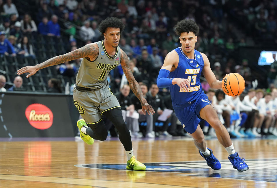UC Santa Barbara guard Ajay Mitchell, right, drives past Baylor forward Jalen Bridges in the first half of a first-round college basketball game in the men's NCAA Tournament, Friday, March 17, 2023, in Denver. (AP Photo/David Zalubowski)
