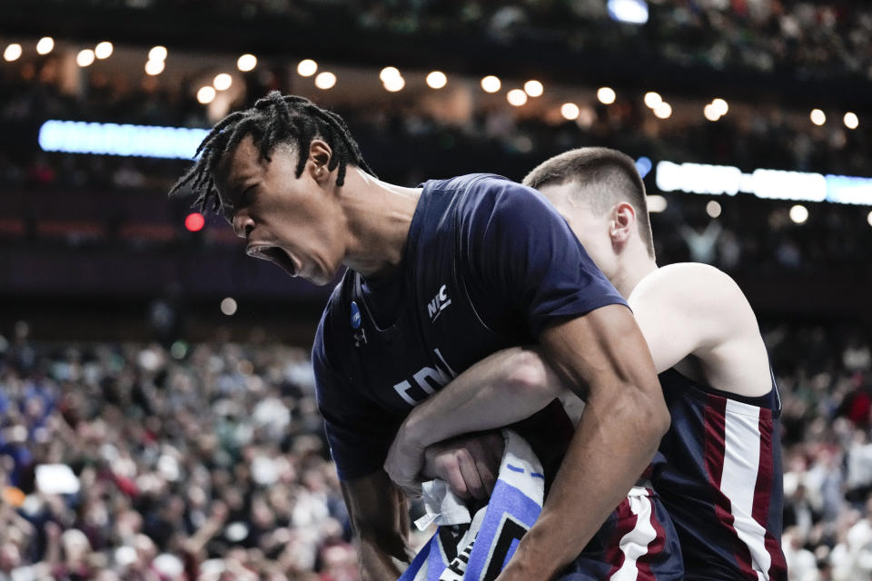 Fairleigh Dickinson forward Sean Moore, left, reacts after a basket against Purdue in the second half of a first-round college basketball game in the NCAA Tournament Friday, March 17, 2023, in Columbus, Ohio. (AP Photo/Paul Sancya)