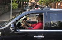 A "Great Dane" dog sits beside its master with its head projecting through the sunroof of an SUV as they drive through traffic in downtown Washington, October 30, 2013. REUTERS/Jim Bourg (UNITED STATES - Tags: SOCIETY ANIMALS)