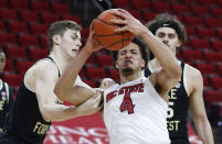 Wake Forest's Jonah Antonio (20) fouls North Carolina State's Jericole Hellems (4) during the first half of an NCAA college basketball game Wednesday, Jan. 27, 2021, in Raleigh, N.C. (Ethan Hyman/The News & Observer via AP, Pool)