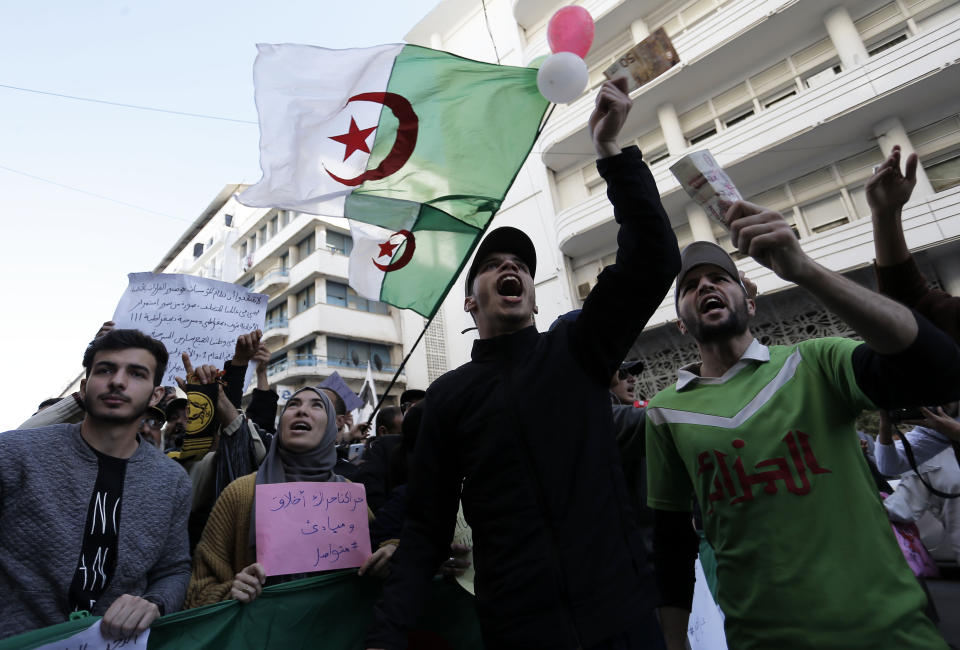In this photo taken on Tuesday, Dec. 24, 2019, students take to the streets in the capital Algiers to protest against the government, in Algeria. (AP Photo/Toufik Doudou)