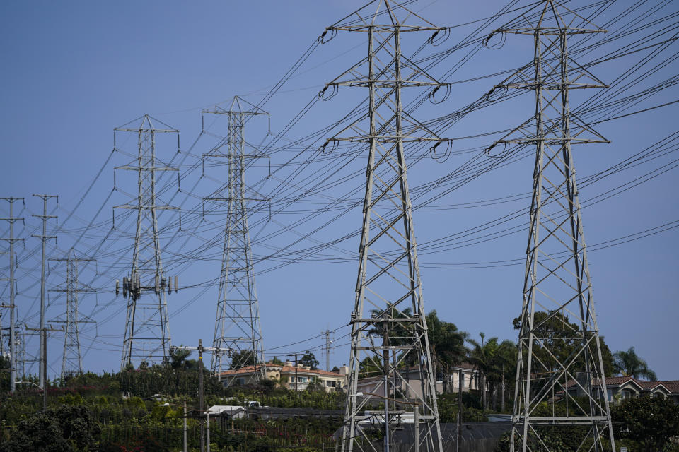 Power transmission towers stand near homes in Redondo Beach, Calif., Wednesday, Sept. 7, 2022. With record demand on power supplies across the West, California snapped its record energy use around 5 p.m. with 52,061 megawatts, far above the previous high of 50,270 megawatts set July 24, 2006. (AP Photo/Jae C. Hong)