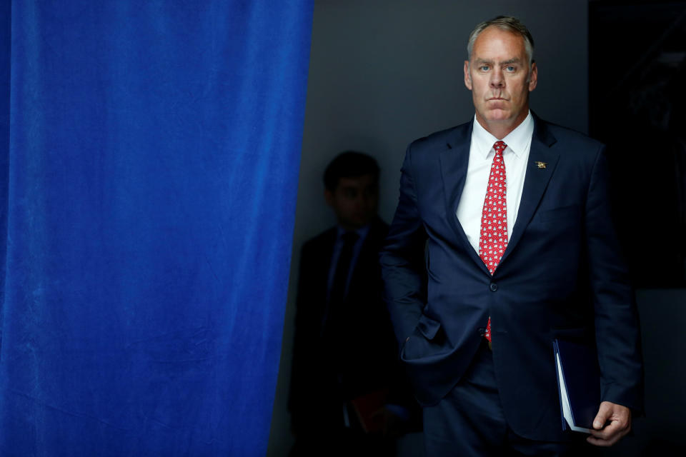 U.S. Interior Secretary Ryan Zinke waits to take the stage with President Trump for a speech on infrastructure in Washington, D.C., in June. (Photo: Jonathan Ernst / Reuters)