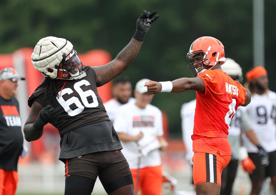 Cleveland Browns quarterback Deshaun Watson, right, celebrates a touchdown with tackle James Hudson III during the NFL football team's football training camp in Berea on Monday.