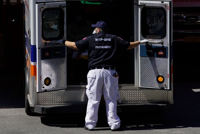 A paramedic closes doors to an ambulance outside Elmhurst Hospital during outbreak of coronavirus disease (COVID-19) in New York