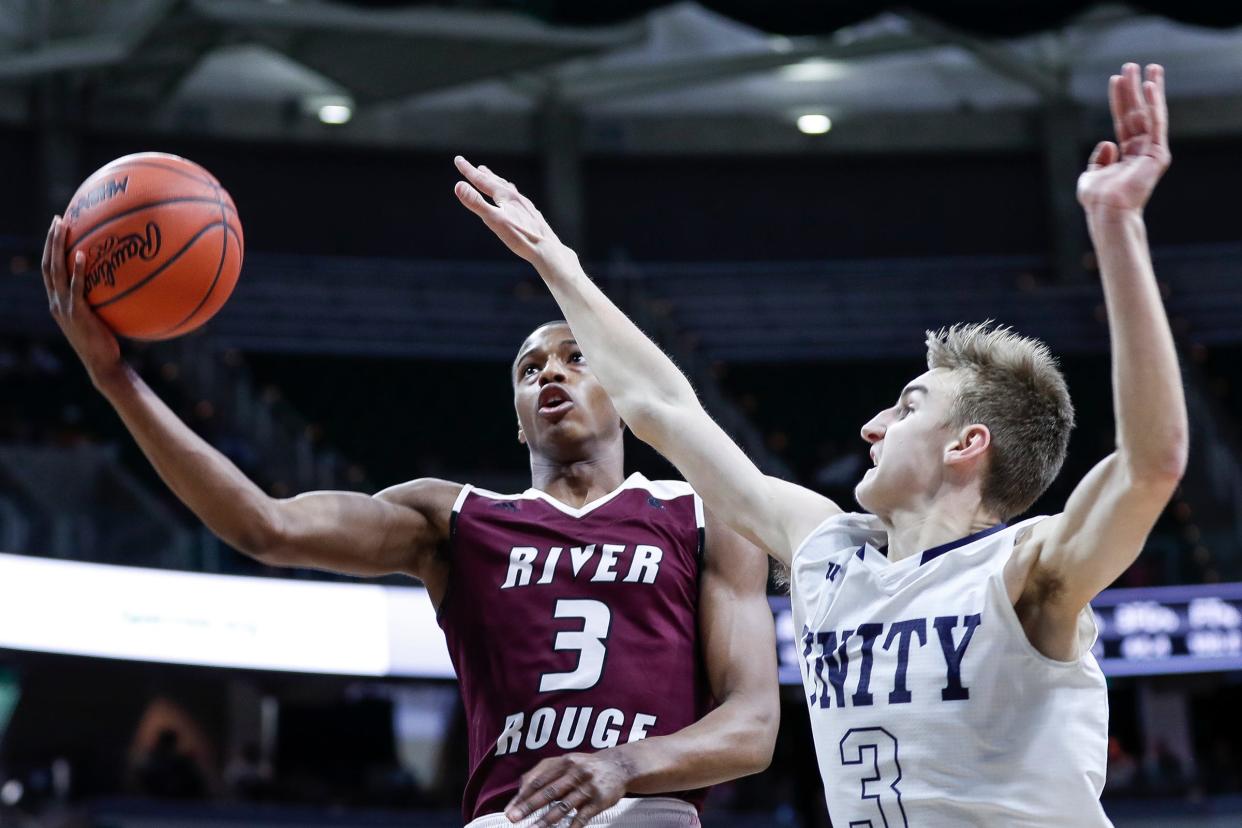 River Rouge's Micah Parrish (3) makes a layup against Hudsonville Unity Christian's Grant Balcer (3) during the first half of MHSAA Division 2 final at the Breslin Center in East Lansing, Saturday, March 16, 2019.