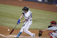 Miami Marlins' Corey Dickerson hits a triple, scoring Adam Duvall and Jon Berti during the sixth inning of a baseball game against the Philadelphia Phillies, Monday, May 24, 2021, in Miami. (AP Photo/Wilfredo Lee)