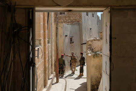 Kurdish forces secure the Easter Mass in Mar Gewargis (St George) Chaldean Catholic church, which was damaged by Islamic State militants, in the town of Tel Esqof, Iraq, April 16, 2017. REUTERS/Marko Djurica